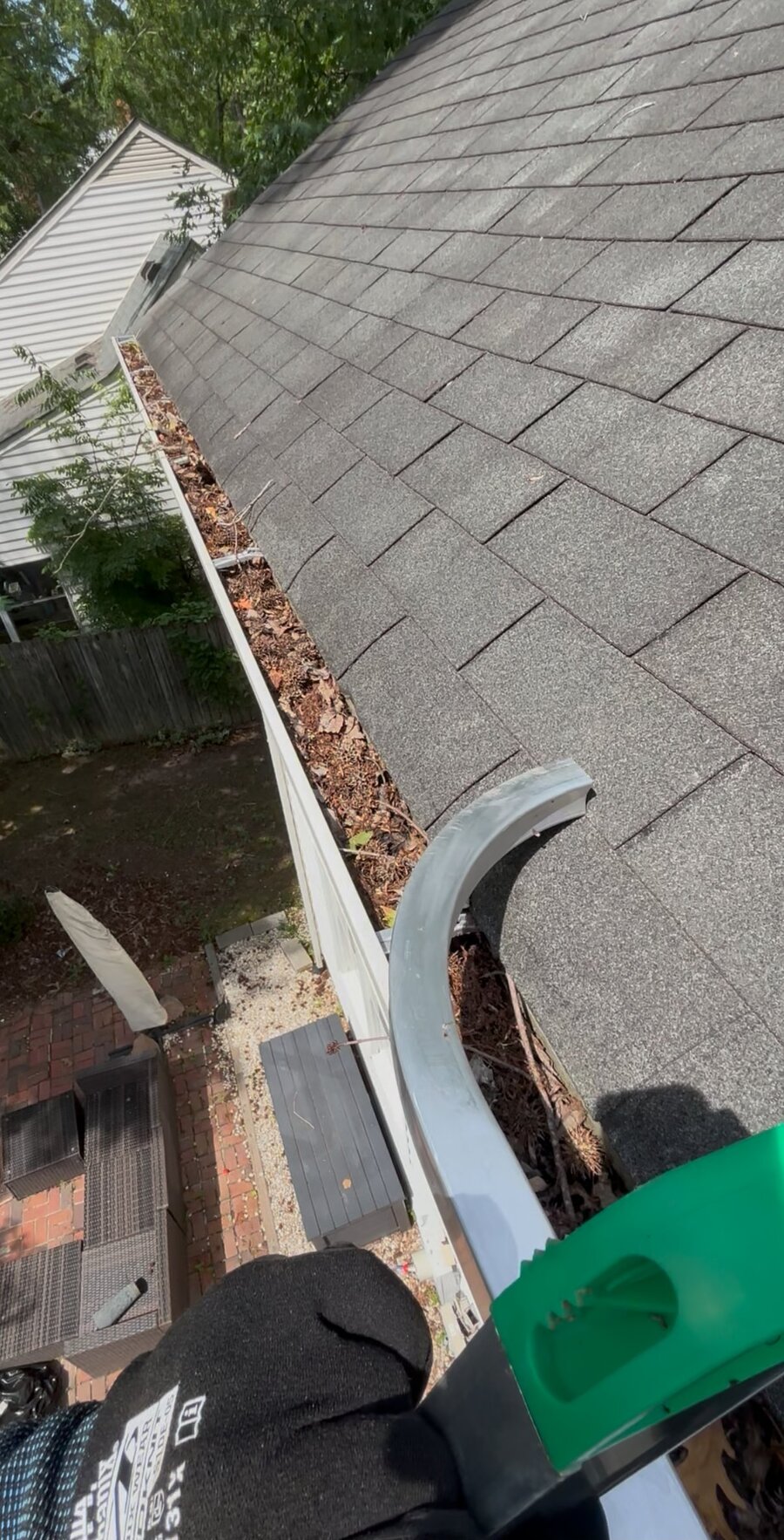Gutter packed with leaves and debris before cleaning